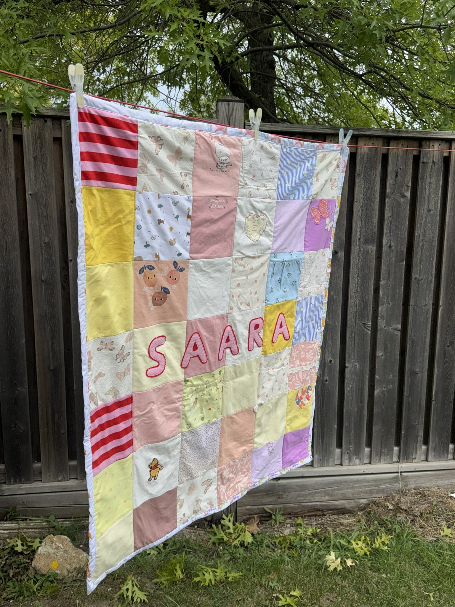 The completed patchwork blanket in the garden